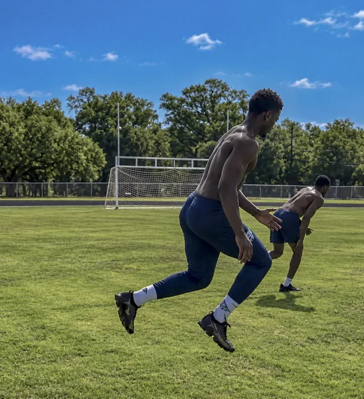 Athletes performing outdoor speed and conditioning drills